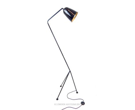 A retro, Italian, tall, black-enamelled standard lamp with a curved, contemporary design, on a tri-pod base with circular fee