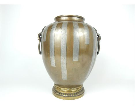 A late 19th century Japanese Bronze vase inlaid with pewter and decorated with ring handles in the shape of blossoming flower