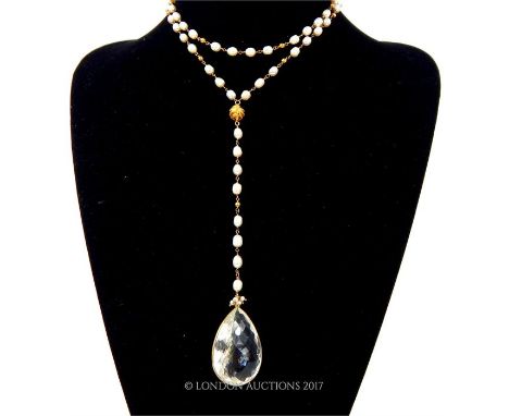 A silver-gilt, freshwater pearl necklace with a faceted, rock, crystal drop, Length: 51 cm.