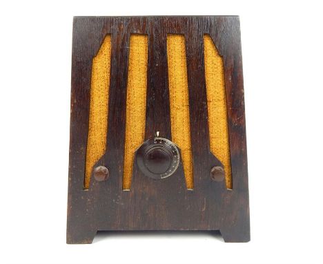 An Art Deco style oak cased radio, with three bakelite tuning knobs, raised on shaped bracket feet, 41 x 27 x 19cm