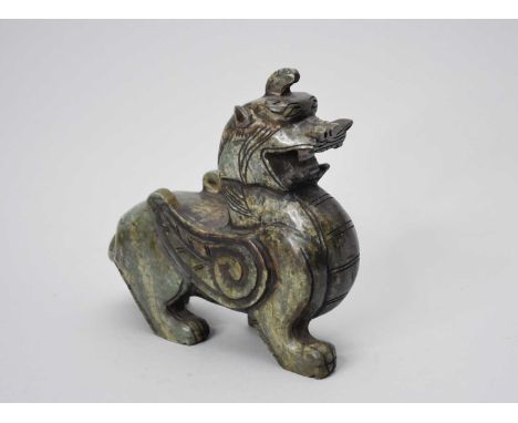 A Chinese dark mottled green jade figure of a male pixiu (tianlu), in typical pose standing four square and with mouth agape,