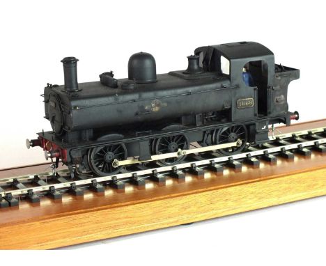 An O-gauge scratch-built model steam locomotive, '1668', 0-6-0, in black livery, with British Railways logo of a lion rampant