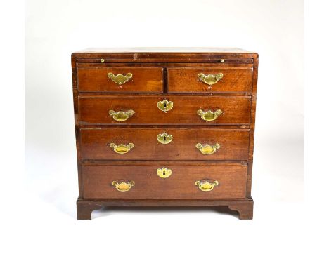 A well proportioned small George III mahogany chest of drawers, with a caddy top, brushing slide, two short and three ovolo l