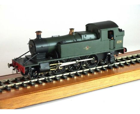 An 7mm scale model of a steam locomotive, '4546', 2-6-2, in green and black livery, with the British Railway logo of a lion r