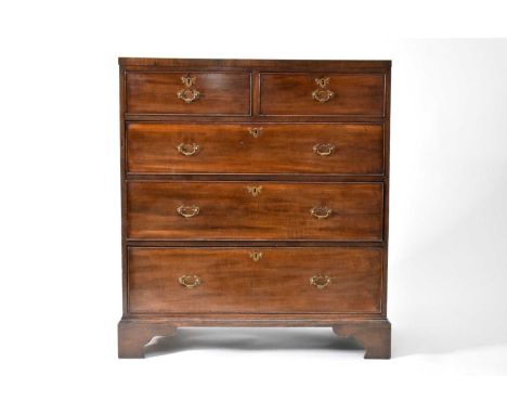 An early 19th century mahogany rectangular chest of drawers, with two short and three long graduated, cock-beaded drawers, on