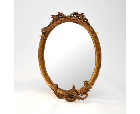 A small Victorian gilt gesso oval girandole, with ribbon and reed moulded frame and fruiting laurel cresting, very damaged, l