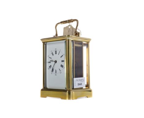 EARLY 20TH CENTURY CARRIAGE CLOCK, with white enamel dial with Roman and Arabic numerals, the brass five glass case with swin