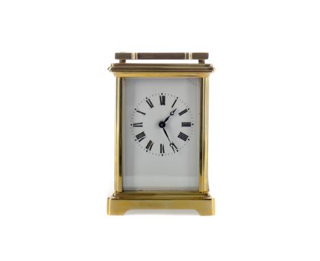 EARLY 20TH CENTURY CARRIAGE CLOCK, with white enamel dial with Roman numerals, the brass five glass case with swing handle, o