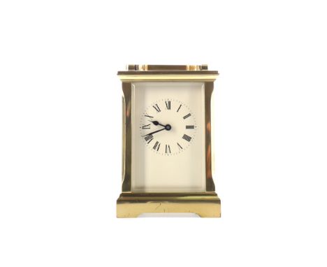 EARLY 20TH CENTURY CARRIAGE CLOCK, with white enamel Roman numeral dial, the brass five glass case with swing handle, on brac