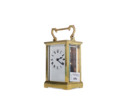 EARLY 20TH CENTURY CARRIAGE CLOCK, with white enamel dial with Roman numerals, the brass five glass case with swing handle, o