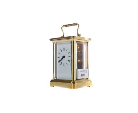 EARLY 20TH CENTURY CARRIAGE CLOCK, with white enamel dial with Roman numerals, the brass five glass case with swing handle, o