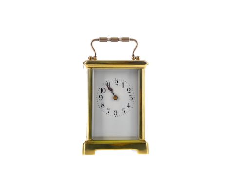 EARLY 20TH CENTURY CARRIAGE CLOCK, with white enamel dial with Arabic numerals, the brass five glass case with swing handle, 