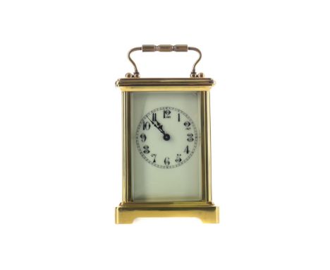 EARLY 20TH CENTURY CARRIAGE CLOCK, the white enamel dial with Arabic numerals, the brass five glass case with swing handle, o