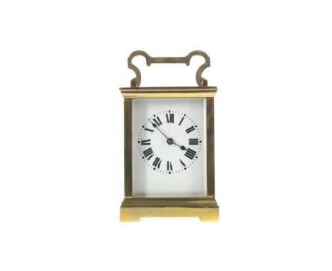 EARLY 20TH CENTURY CARRIAGE CLOCK, with white enamel dial with Roman numerals, the brass five glass case with swing handle, t