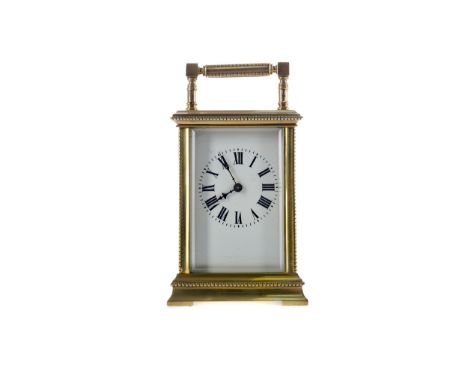 EARLY 20TH CENTURY CARRIAGE CLOCK, with white enamel dial with Roman numerals, the brass five glass case with beaded borders,