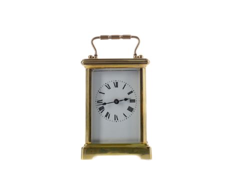 EARLY 20TH CENTURY CARRIAGE CLOCK, with white enamel dial with Roman numerals, the brass five glass case with swing handle, o