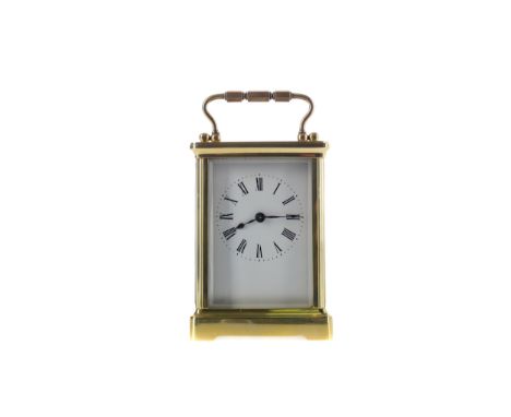 EARLY 20TH CENTURY CARRIAGE CLOCK, with white enamel dial with Roman numerals, the brass five glass case with swing handle, o