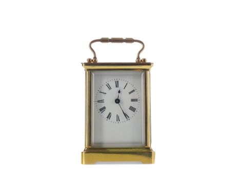 EARLY 20TH CENTURY CARRIAGE CLOCK, with white enamel dial with Roman numerals, the brass five glass case with swing handle, o
