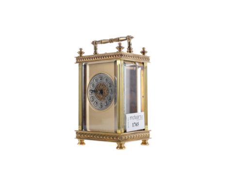 EARLY 20TH CENTURY CARRIAGE CLOCK, with gilt dial and silvered Arabic numeral chapter ring, contained in a pillared brass fiv
