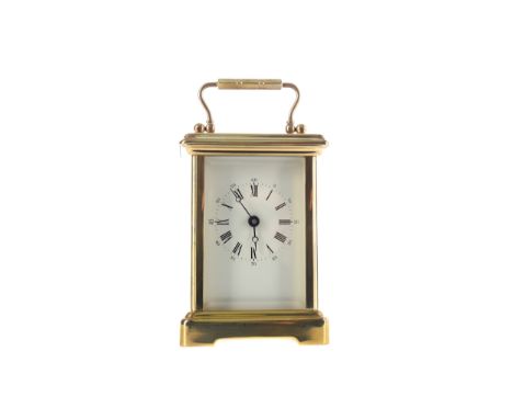EARLY 20TH CENTURY CARRIAGE CLOCK, with white enamel dial with Roman and Arabic numerals, the brass five glass case with swin