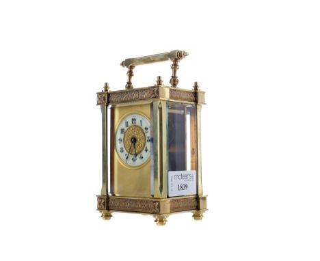 EARLY 20TH CENTURY CARRIAGE CLOCK, the gilt dial with white enamel Arabic numeral chapter ring, the brass five glass case wit