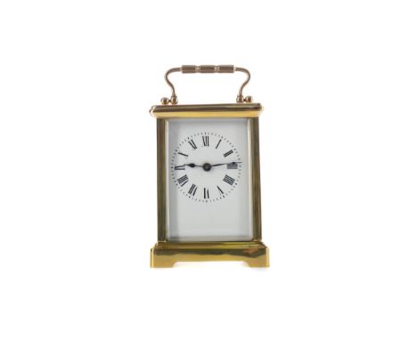 EARLY 20TH CENTURY CARRIAGE CLOCK, with white enamel dial with Roman numerals, the brass five glass case with swing handle, o