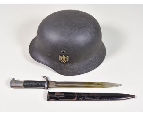 A German World War II Helmet, painted, with single decal, serial no. 066 and 373 to rear, leather inset, size 58, and a Germa