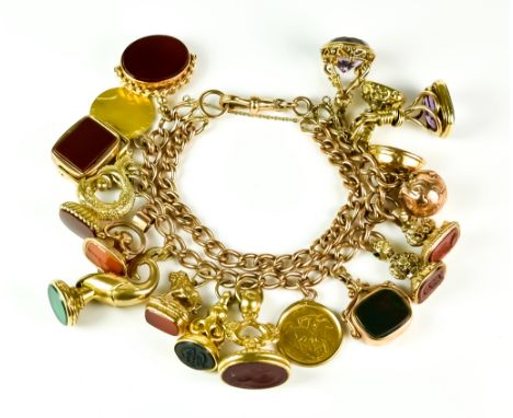 A 9ct Gold Charm Bracelet, 20th Century, suspended with eighteen charms, various, including one half guinea, a 1909 half sove