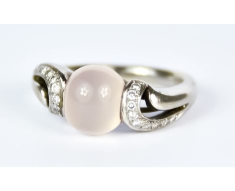 An 18ct White Gold Rose Quartz and Diamond Ring, Modern, set with a centre cabochon rose quartz stone flanked by small diamon