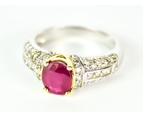 A Ruby and Diamond Ring, Modern, in 14ct white gold mount, set with a central faceted ruby, approximate weight 1ct, surrounde