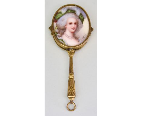 A Late 19th/Early 20th Century Gilt Brass and Porcelain Miniature Hand Mirror, the porcelain back enamelled in colours with a