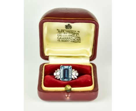 A Platinum, Aquamarine and Diamond Ring, retailed by Garrard & Co. of London, set with a centre faceted aquamarine stone, app