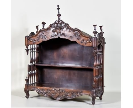 A 19th Century Walnut Wall Shelf, of shaped outline, the frieze carved with a basket of flowers and floral ornament with a si