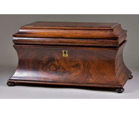 An Early Victorian Figured Rosewood Tea Caddy, of sarcophagus shape, the interior fitted with cut glass bowl and lidded compa