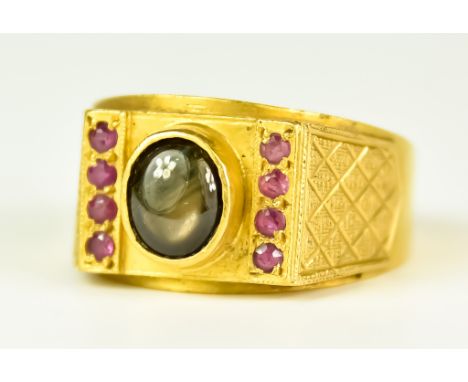 A 22ct Gold Ruby and Gem Stone Ring, Modern, set with a centre cabochon gem stone and eight small ruby stones, size V, gross 