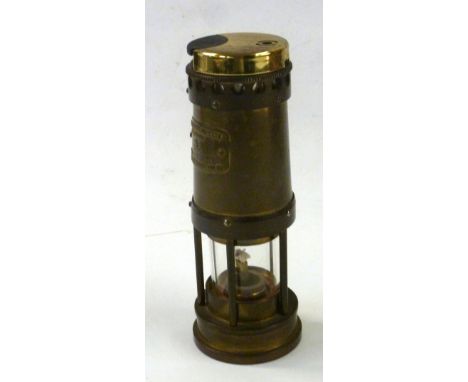 A SMALL MINERS SAFETY LAMP WITH LIGHTER FITTED TO THE TOP 