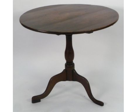 EIGHTEENTH CENTURY OAK OCCASIONAL TABLE, the circular top above a slender vase shaped column and raised on downswept tripod s