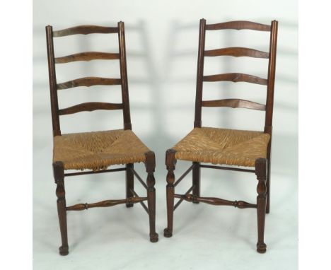 SET OF SIX STAINED BEECH AND FRUITWOOD LADDER BACK SINGLE DINING CHAIRS, of typical form with rush seats and turned forelegs 