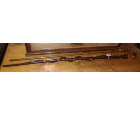 A silver banded walking cane and a walking stick with entwined snake