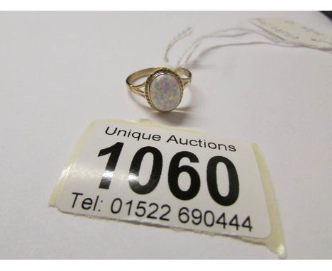 A 9ct gold ring set opal, size O