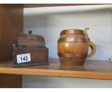 A tobacco jar in the shape of a barrel and an oak cigarette dispenser