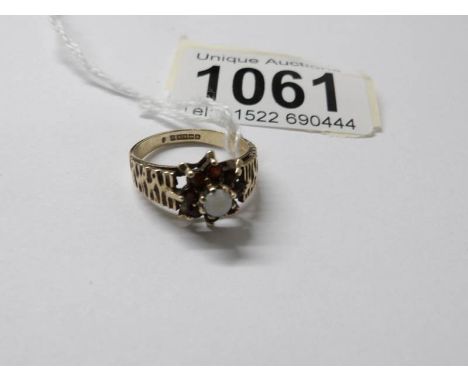 A 9ct gold opal and sapphire ring, size L