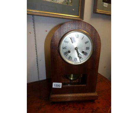 A mahogany bracket clock with cut glass panel and silvered dial