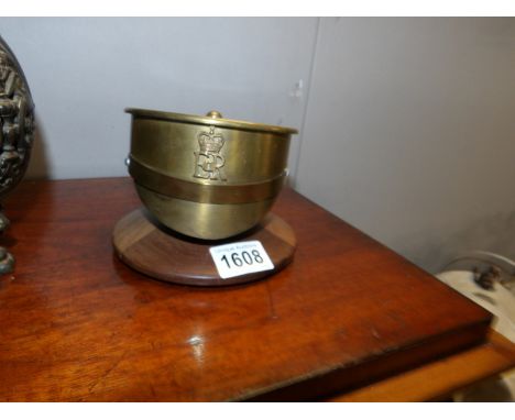 A brass trench art shell case in the shape of a cap
