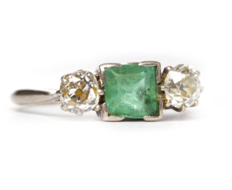 EARLY TWENTIETH CENTURY EMERALD AND DIAMOND THREE STONE RINGthe central square step cut emerald 6mm and flanked by two oval c