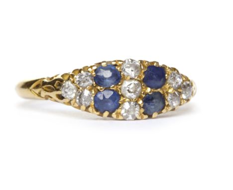 VICTORIAN EIGHTEEN CARAT GOLD SAPPHIRE AND DIAMOND RINGthe elliptical bezel set with two pairs of cushion shaped sapphires in