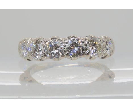 AN 18CT WHITE GOLD SIX STONE DIAMOND RING set with two 0.20cts and four 0.30cts brilliant cut diamonds taking the estimated a