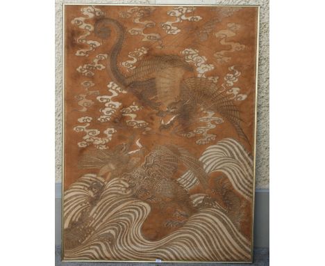 A CHINESE EMBROIDERED PANEL with a large sinuous dragon above a raging sea, woven in silk and metal threads, 198cm x 146cm Th