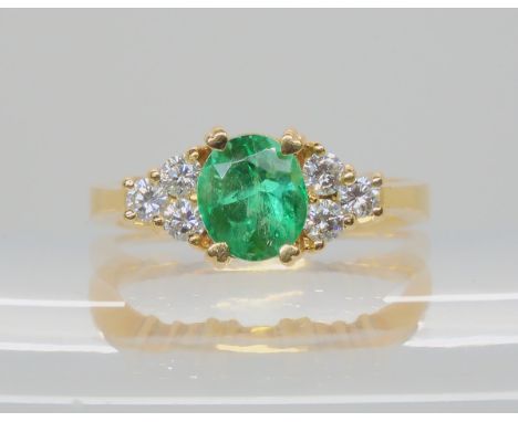 AN EMERALD AND DIAMOND RING mounted in bright yellow metal, emerald approx 7.7mm x 6.7mm x 5.9mm, further set with six diamon