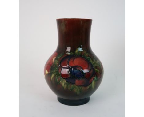 A MOORCROFT FLAMBE ANEMONE PATTERN VASE of baluster form and straight neck, partial Queen Mary label to base, 17cm high Condi